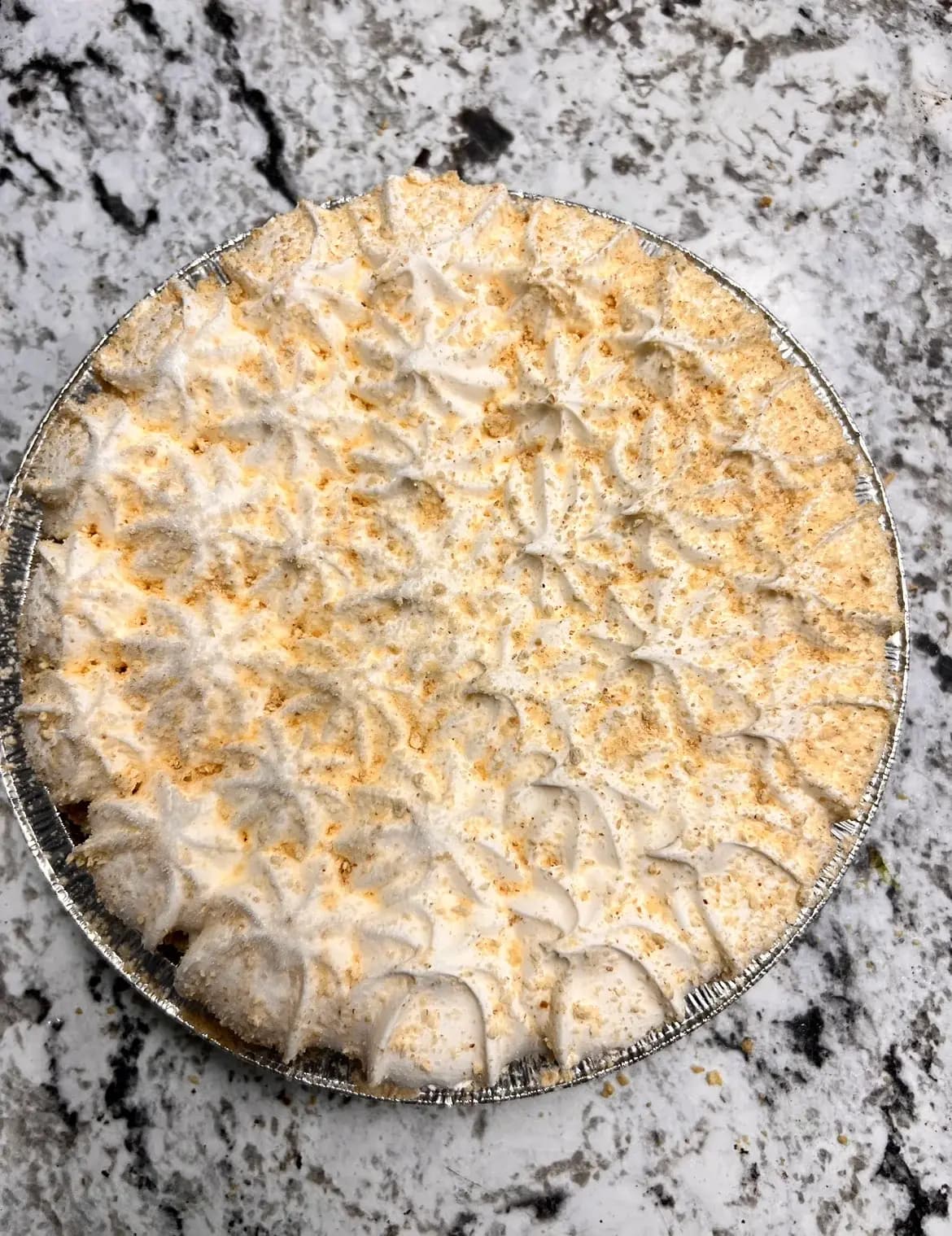 A whipped-cream-topped cream pie from the Lewis Farms bakery freezer case